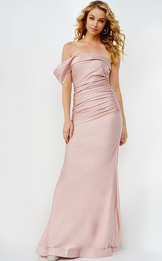 Woman wearing the Jovani 07640 One-Shoulder Long Prom Dress, featuring a light pink, fitted bodice and floor-length design, posing against a plain background.